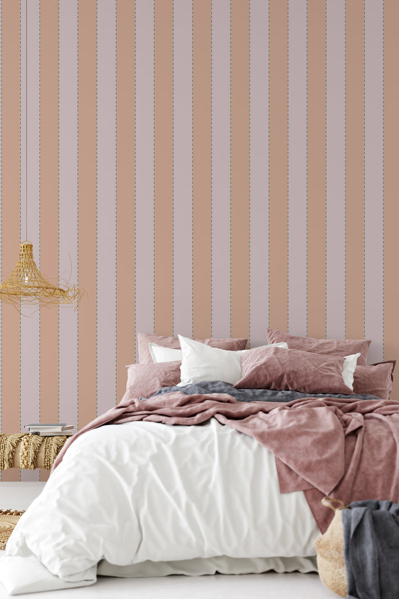 Pink and beige vertical fabric stripes with delicate dotted accents on a smooth surface, enhancing the classic and elegant feel of the room. Traditional wallpaper.