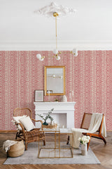 A room with a wall covered in red and white abstract brush line wallpaper, adding a modern twist to traditional wallpaper.