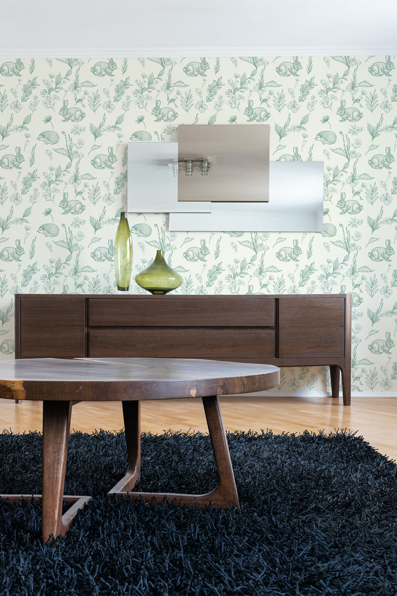 A serene sage green nursery wallpaper with a delicate forest pattern of trees and animals, adding a touch of nature-inspired charm to the room's decor, traditional wallpaper.