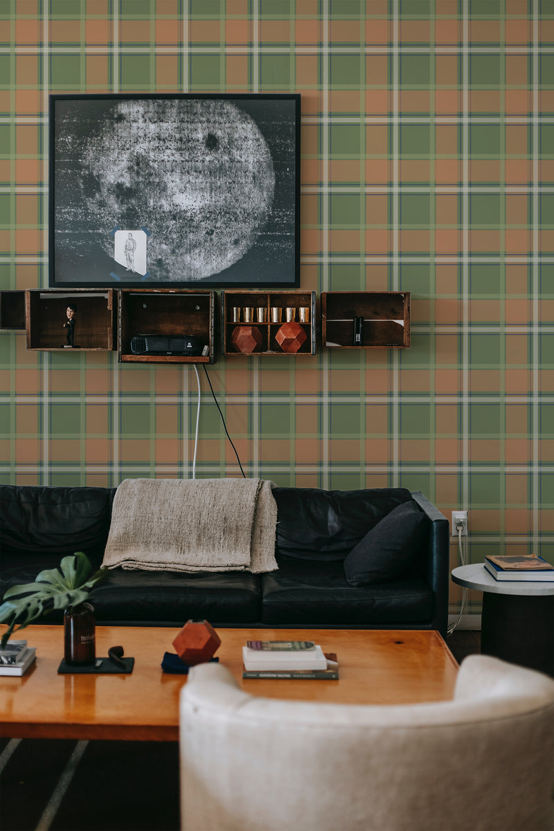 Autumn farmhouse plaid wallpaper with intersecting lines in shades of green and orange creating a cozy checkered pattern on a room wall, evoking a warm, traditional wallpaper ambiance.