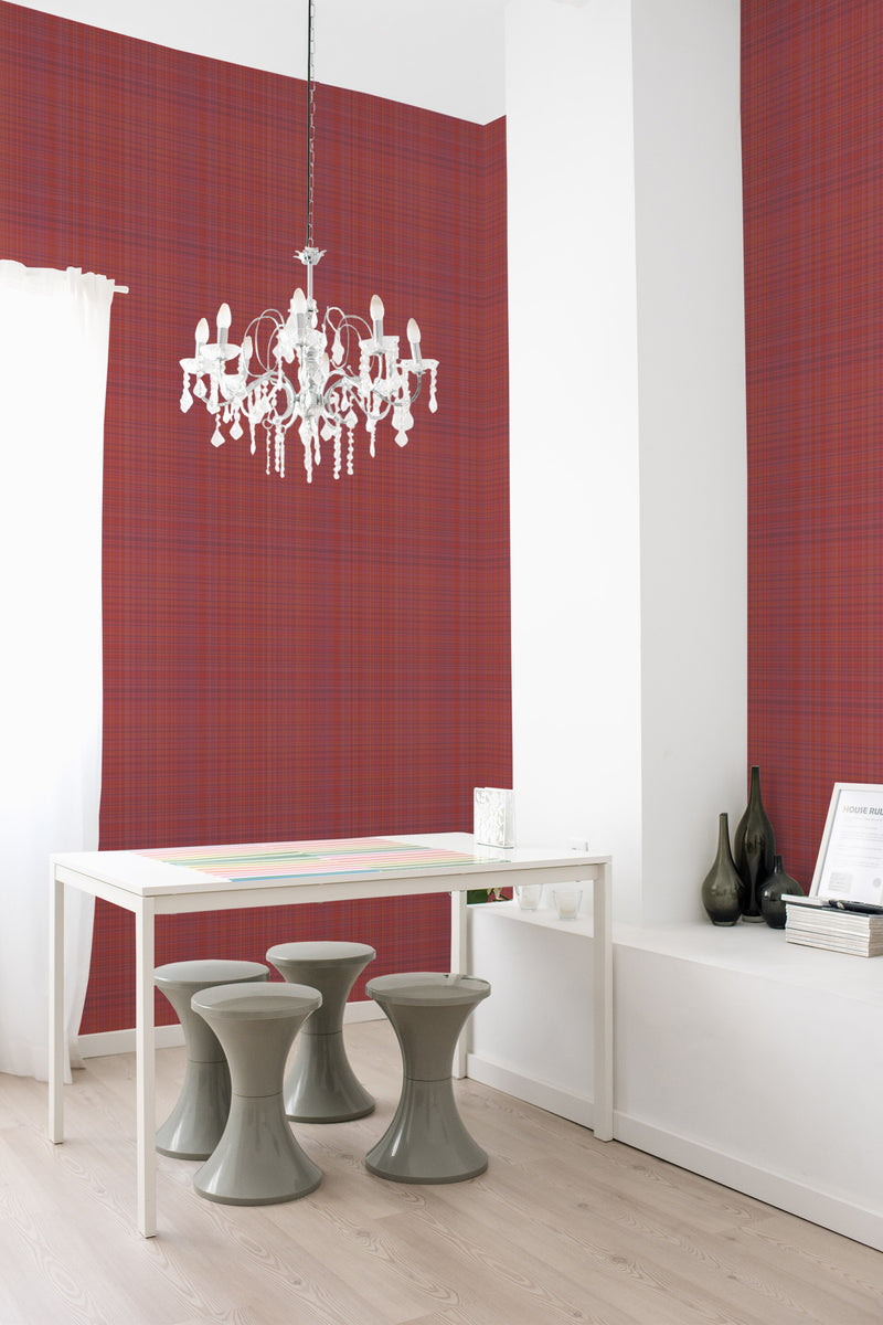 A room with Classic red plaid wallpaper on one wall, combining deep red and darker lines to create a checkered pattern, giving the space a cozy and traditional wallpaper look.