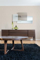 A room with a wall covered in beige wallpaper with a subtle, repeated leaf pattern, complemented by modern wooden furniture, against the traditional wallpaper backdrop.