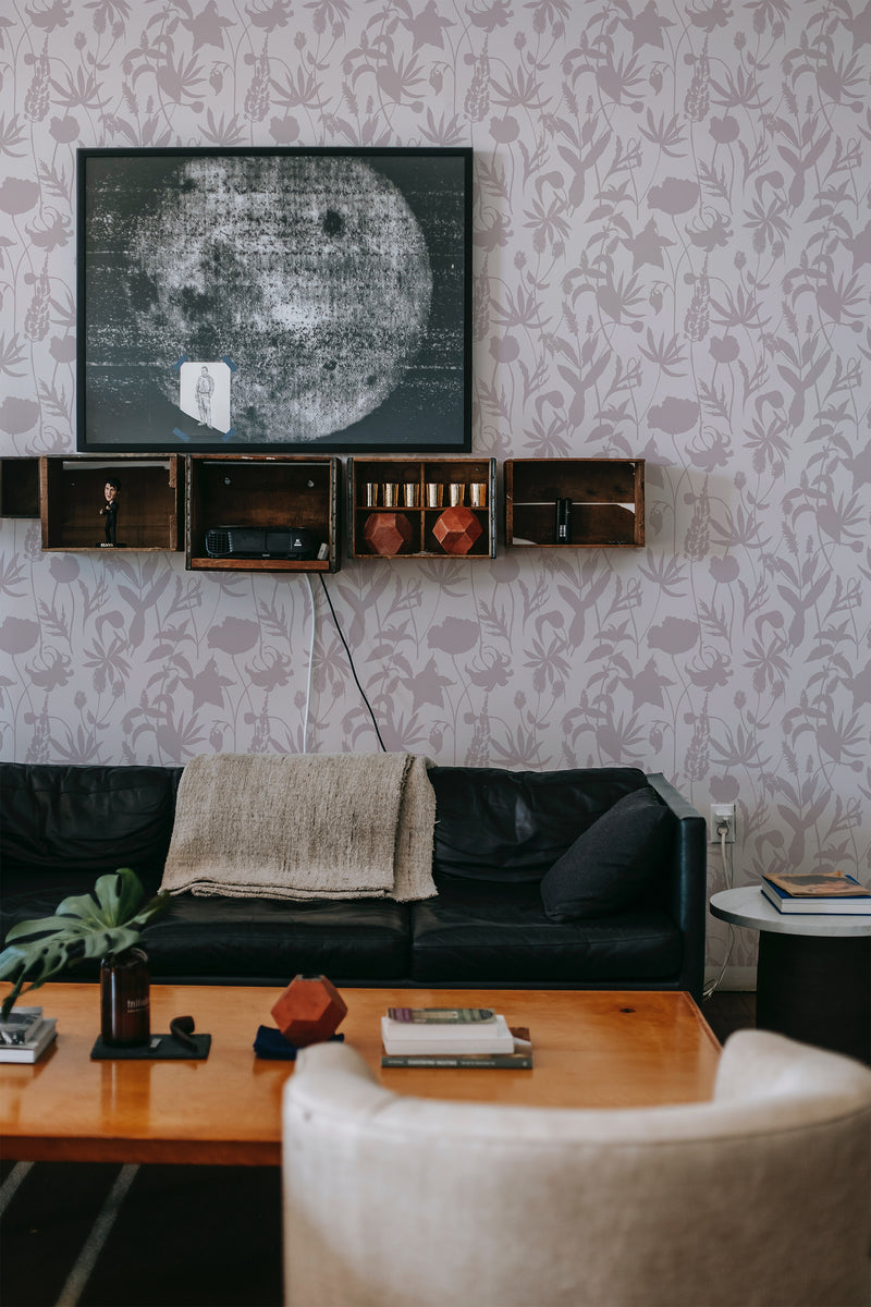 A cozy room with walls adorned with a Floral Shadows patterned wallpaper, blending muted tones and subtle shadow-like florals, adding an elegant touch to the traditional wallpaper.