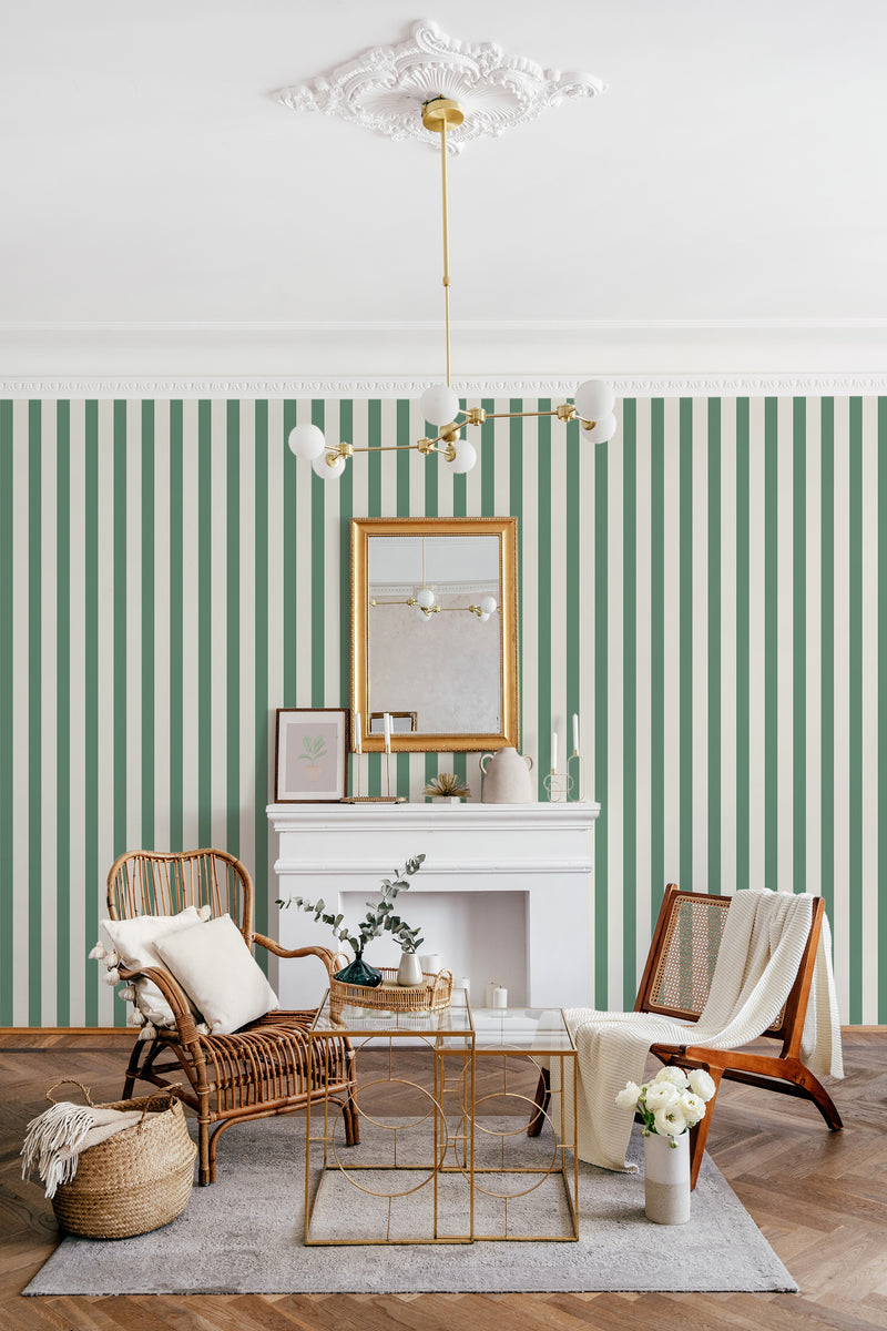 A room with green and white striped wallpaper, a white fireplace, elegant gold-framed mirror, and stylish seating arrangements under a decorative ceiling fixture, exemplifying traditional wallpaper.