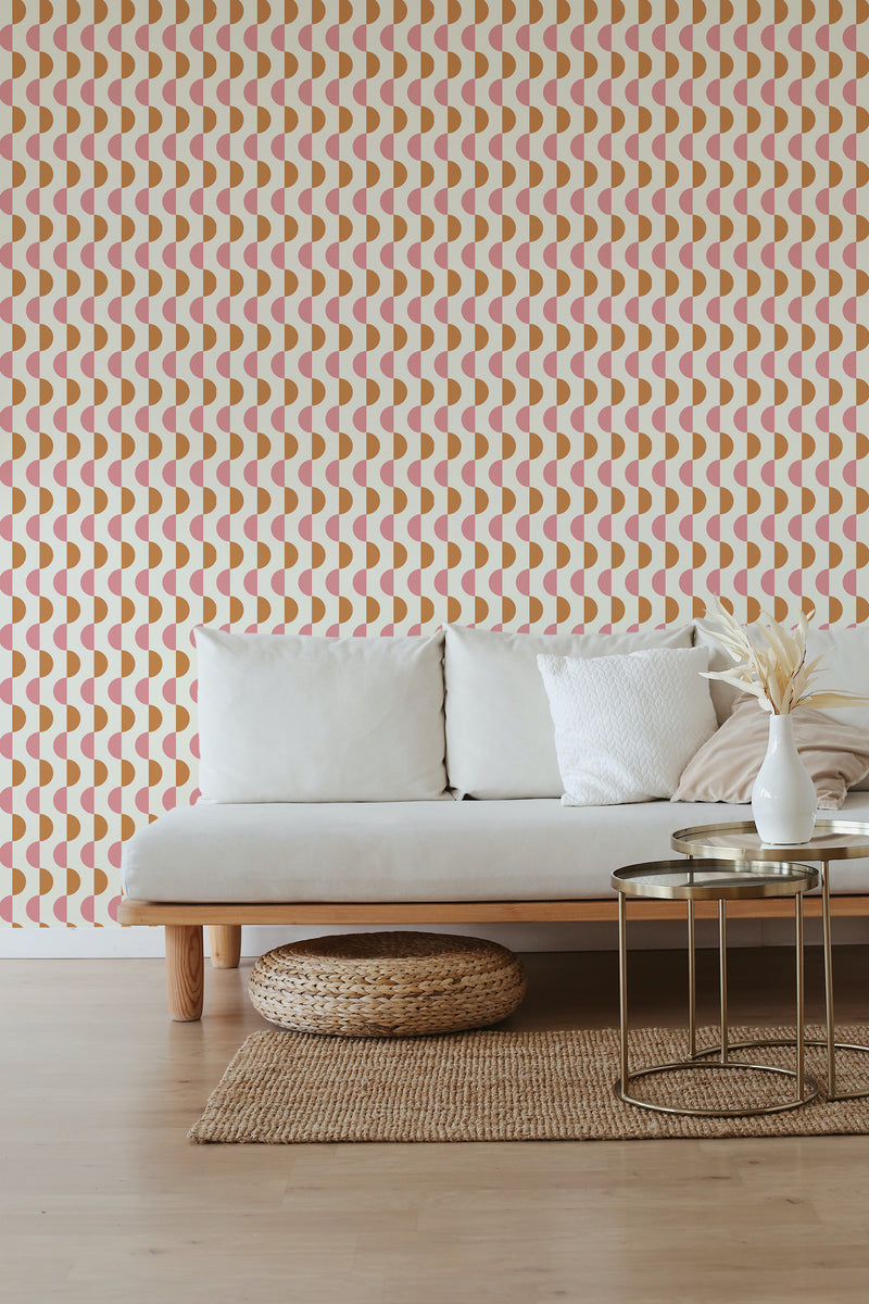 A room with a wall covered in Mid-century half circles wallpaper, composed of repeating semi-circles in orange and beige tones, creating a retro vibe, above a minimalist couch, traditional wallpaper.