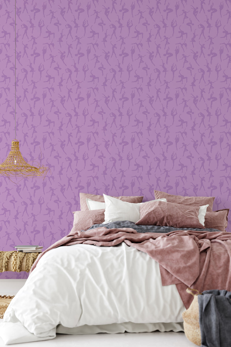 A bedroom wall covered with purple wallpaper patterned with silhouettes of ballerinas, complementing the room's elegant decor, traditional wallpaper.