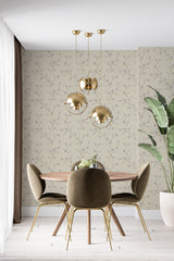 Neutral tree branch pattern on beige background covering a room's wall, creating a serene and natural look in a dining area, complemented by modern furniture and lighting, traditional wallpaper.