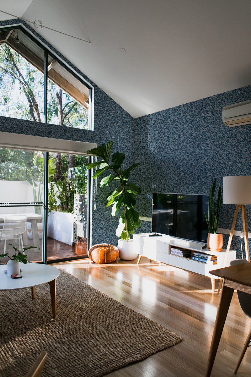 A cozy room with walls covered in dark seamless leaves patterned wallpaper, adding a sophisticated touch of nature to the interior design, traditional wallpaper.