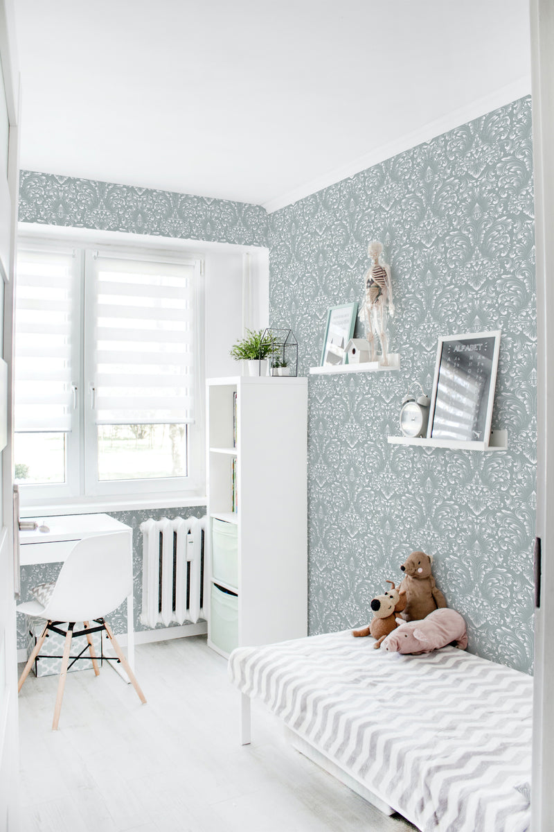 A room with light grey Classic Damask wallpaper with a white flowing pattern, including a bed, shelf, and window, with the ambiance of traditional wallpaper.