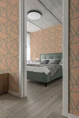 A bedroom with Peachy Line wallpaper pattern of interlocking geometric lines in peach tones on one wall, complementing the modern interior with a green bed and wooden floor, traditional wallpaper.