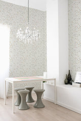 A room with a wall covered in Spring cottage-style wallpaper with small, delicate floral patterns in subtle colors, accented by a white chandelier and modern furniture, embodying a traditional wallpaper.