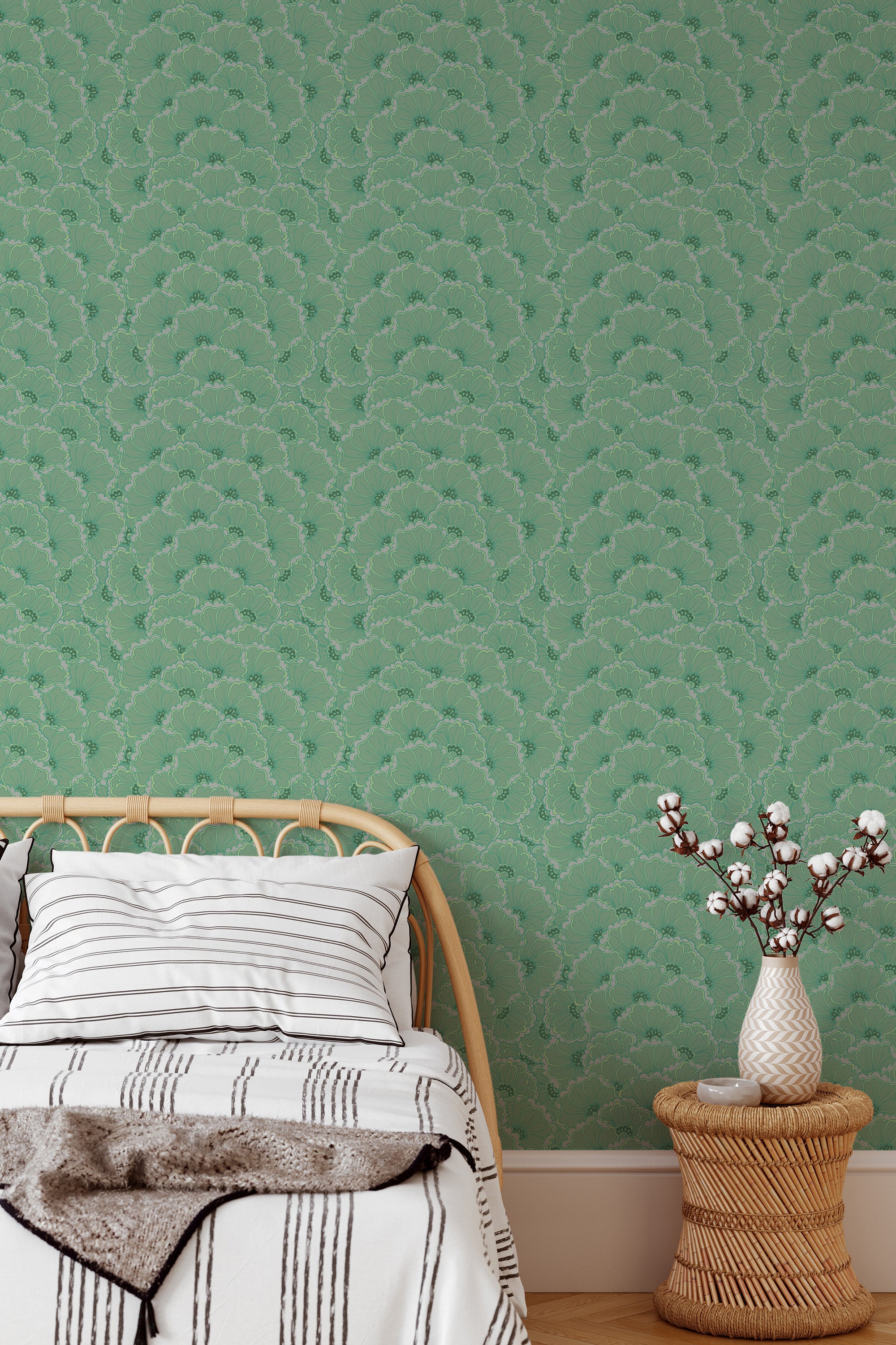 Self-adhesive green retro floral wallpaper with an overlapping leaf pattern on a bedroom wall, complementing a wood bed frame and a vase with branches.