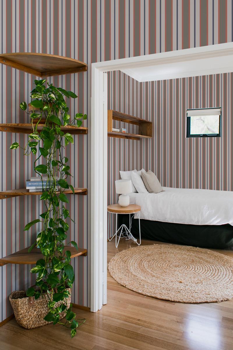 A room with Classic earthy striped wallpaper with alternating shades of brown, beige, and burgundy on the walls, complementing the wooden furnishings, traditional wallpaper.