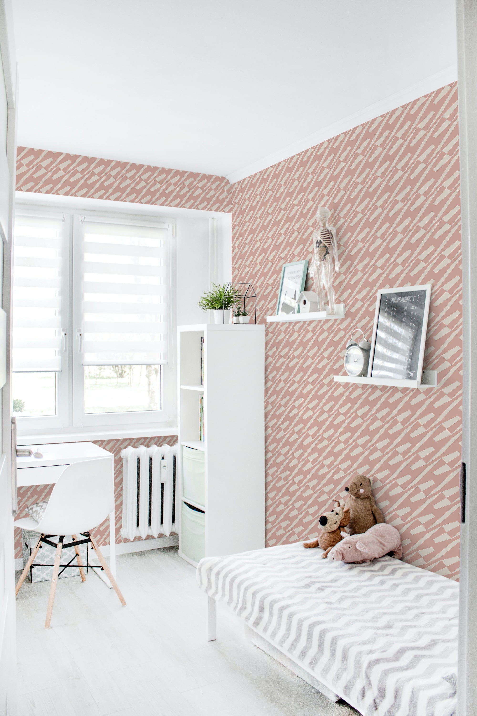 A room with white furniture and a pink and white geometric patterned traditional wallpaper.
