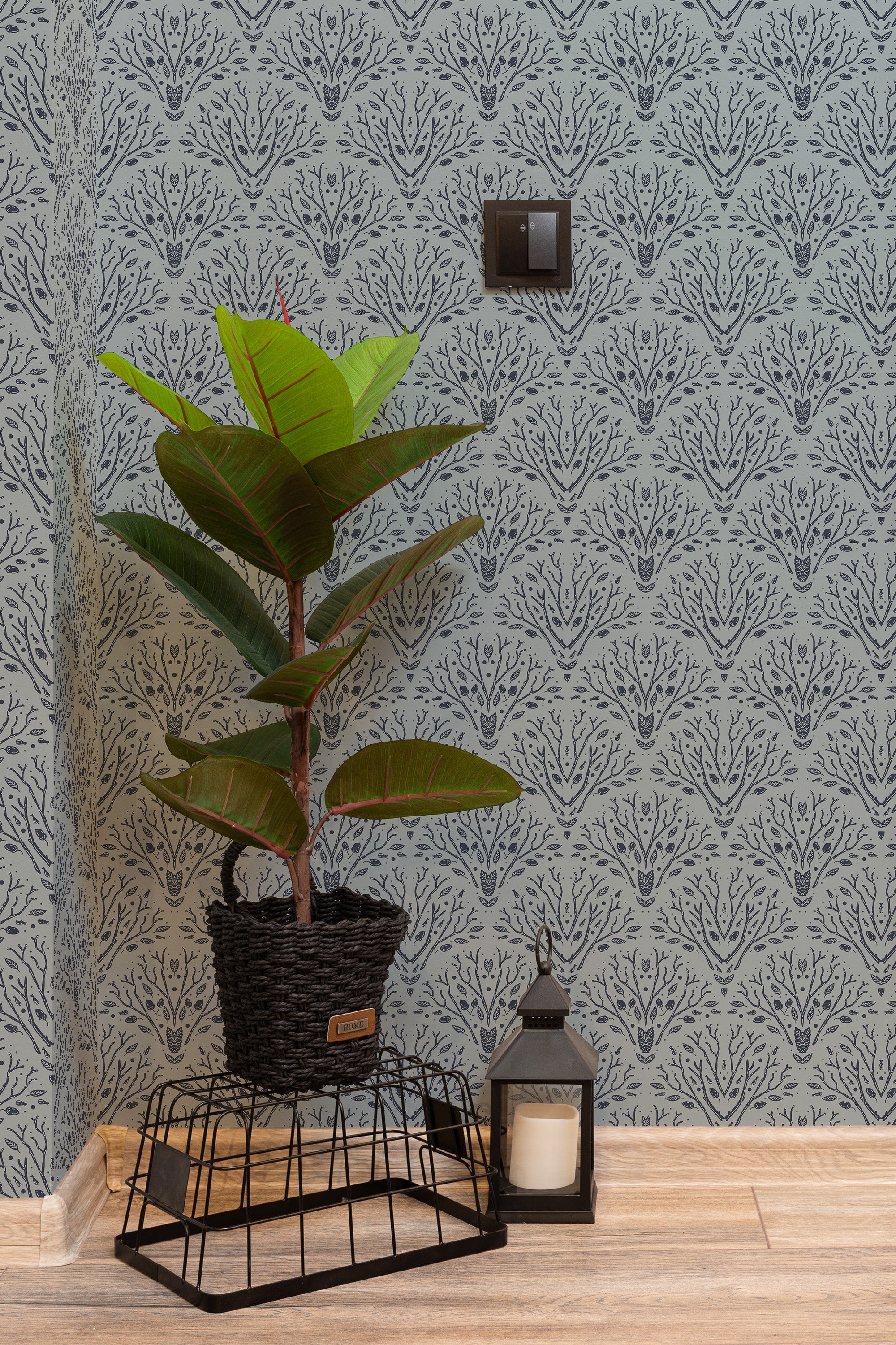 Self-adhesive wallpaper with a repeating Art Deco tree motif in a cool gray tone, accentuating a modern room's decor.