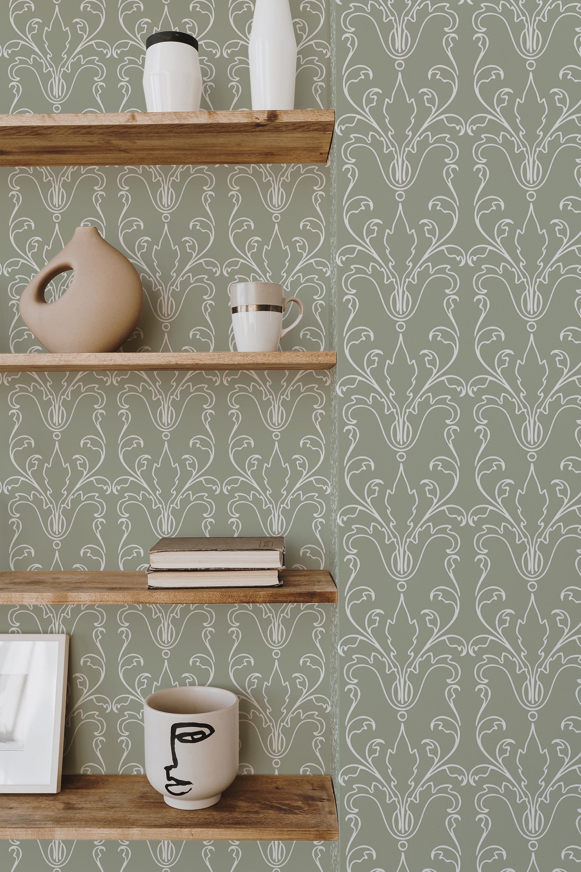 Self-adhesive Art Deco Lines wallpaper with elegant geometric patterns on a green background, accentuated by wooden shelves with decorative items.