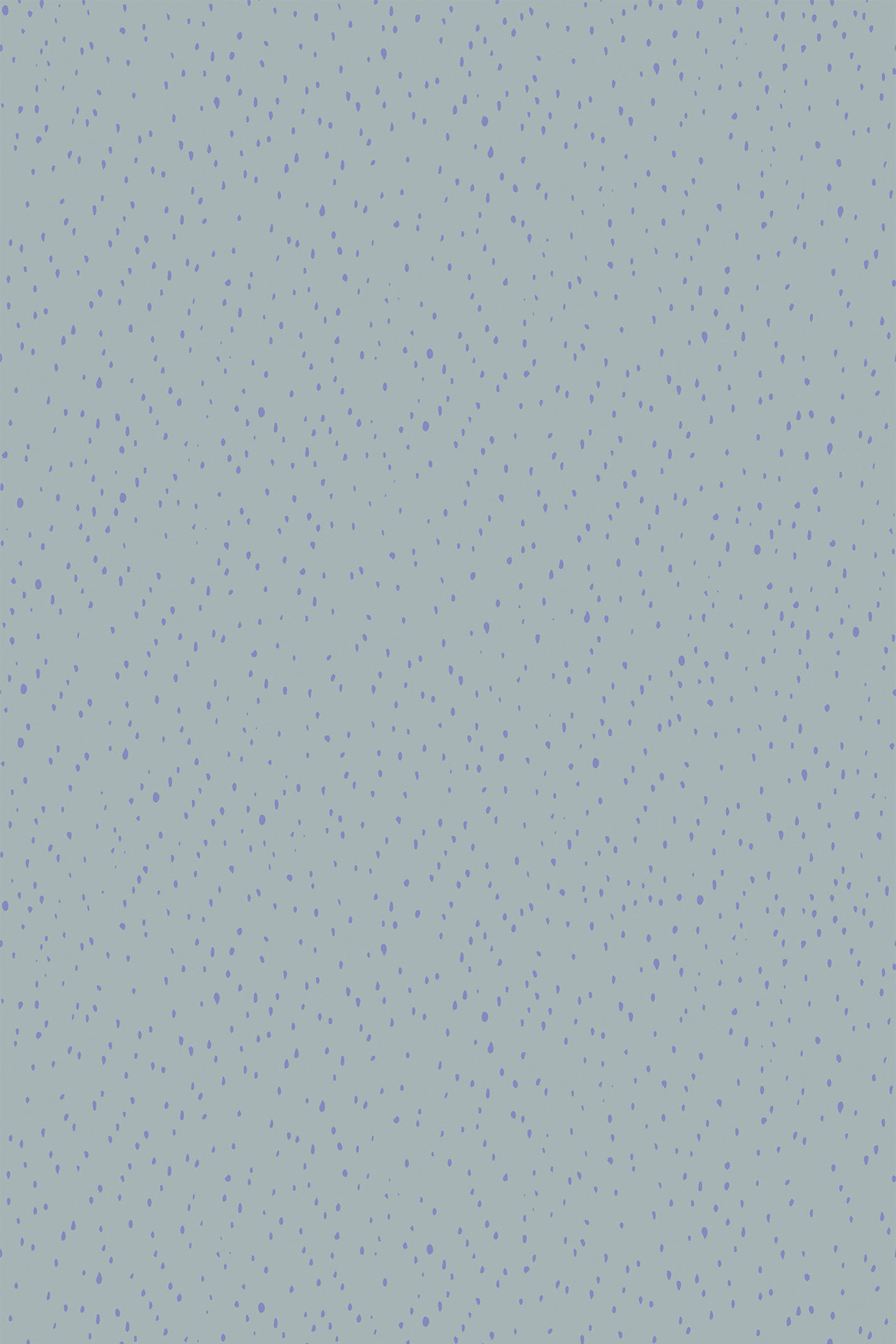 A seamless pattern of small green and purple spots scattered across a light blue background on peel and stick removable wallpaper.