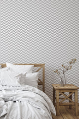 simple bedroom bed nightstand decorative vase elegant gray herringbone wall decor