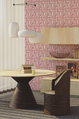 Wallpaper with a repeating thin brush line geometric pattern in red and white tones covering a room's wall, adding a modern twist to traditional wallpaper.