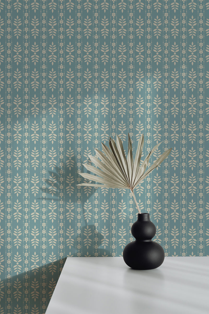 Self-adhesive wallpaper with a classic leaf pattern in muted tones, accentuated with simple flower motifs, on a soft blue background.