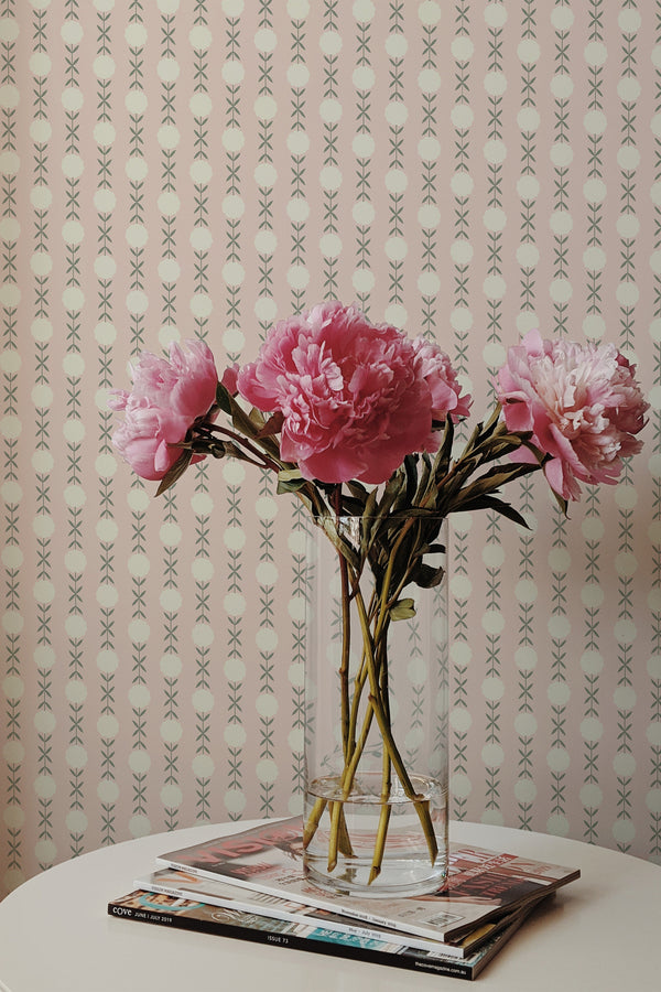 Self-adhesive wallpaper with a Cute Soft Cotton Pattern of delicate pink florals and soft green leaves on a subtle pastel background in a room, accompanied by a vase of pink peonies on a table.