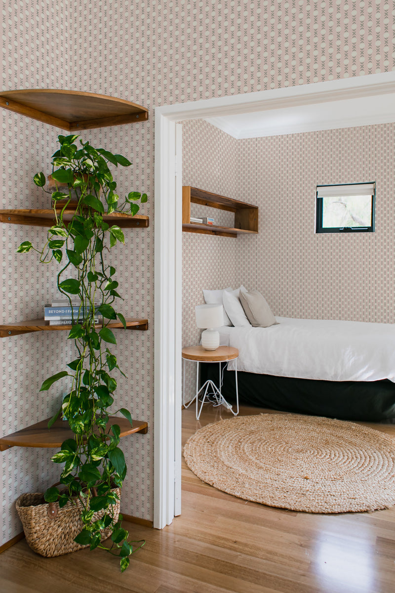 A cozy room with tan Cute Soft Cotton Pattern wallpaper, dotted designs creating a warm, inviting texture, complementing the wooden accents and greenery, traditional wallpaper.