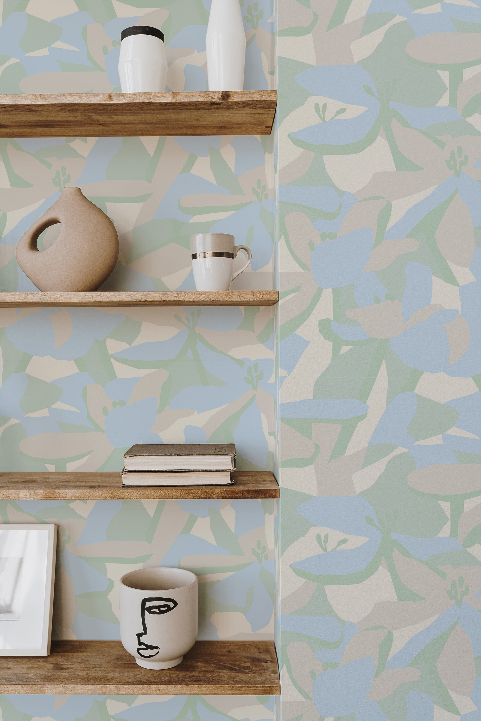 Self-adhesive wallpaper with a soft floral pattern in pastel blue and green hues on a beige background, providing a relaxed and modern aesthetic to the room.