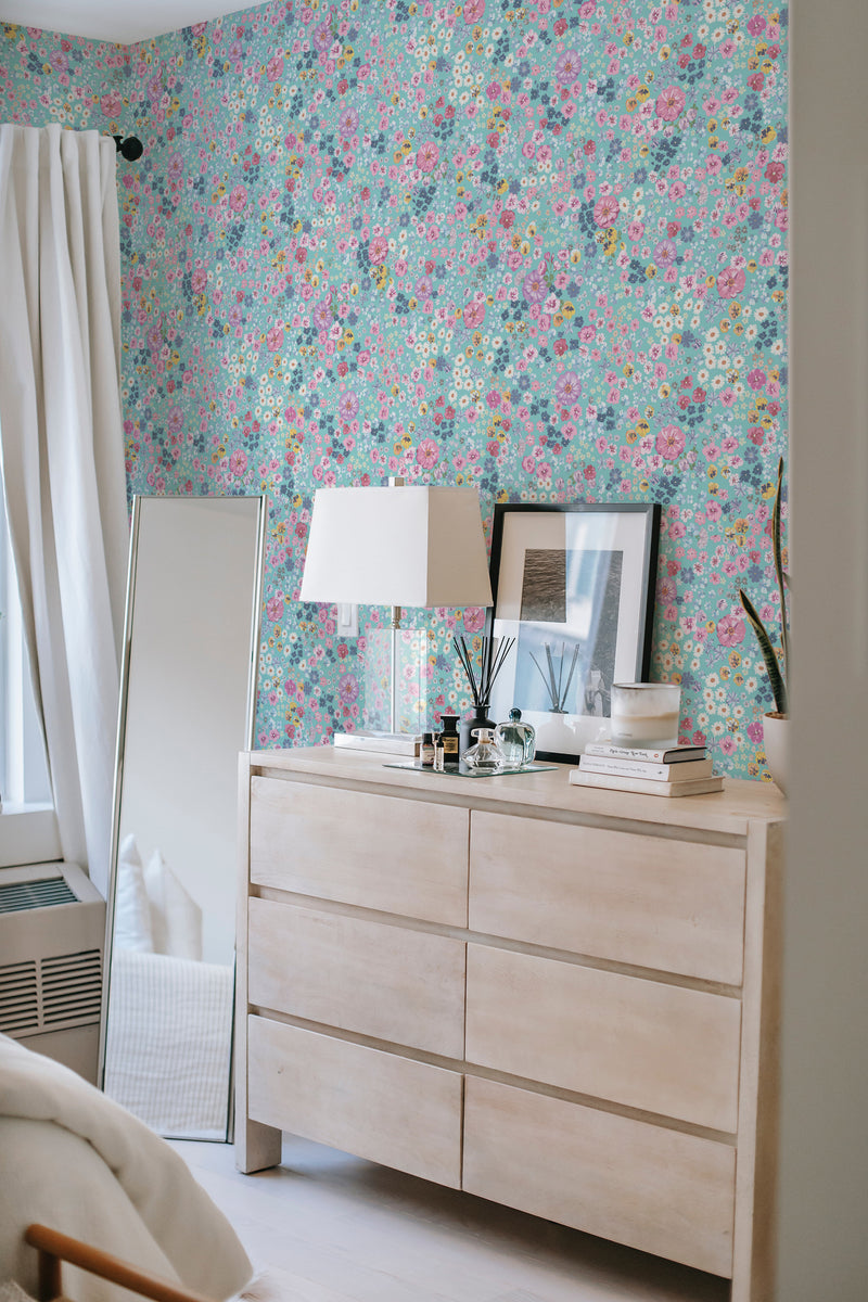 A vibrant blue wallpaper adorned with small pink, yellow, and green floral patterns, creating a charming and traditional wallpaper aesthetic.