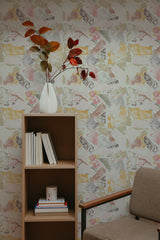 Self-adhesive wallpaper with a wood texture design and vintage newspaper print in a room with a bookshelf and a vase with leaves.