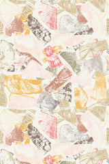 A collage of tree ring cross-sections in warm tones of pink, orange, and beige printed on a peel and stick removable wallpaper.