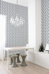 A room with white and blue Seamless Wildflower pattern wallpaper on one wall, complemented by a modern white table, two grey stools, and a crystal chandelier, traditional wallpaper.