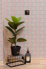 Self-adhesive wallpaper with colorful geometric patterns in a kids' room, alongside a potted plant, and a lantern on a wooden floor.