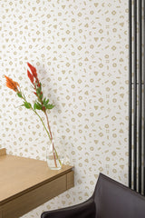 Self-adhesive wallpaper with a playful geometric pattern in neutral colors, suitable for a children's room, alongside minimalist furniture.