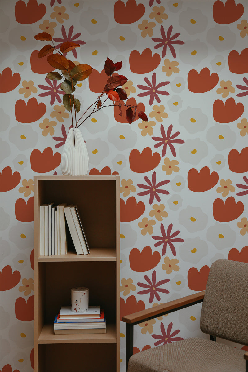 Self-adhesive wallpaper with a bold abstract tulip pattern in orange, red, and brown hues on a cream background, decorating a room's wall.