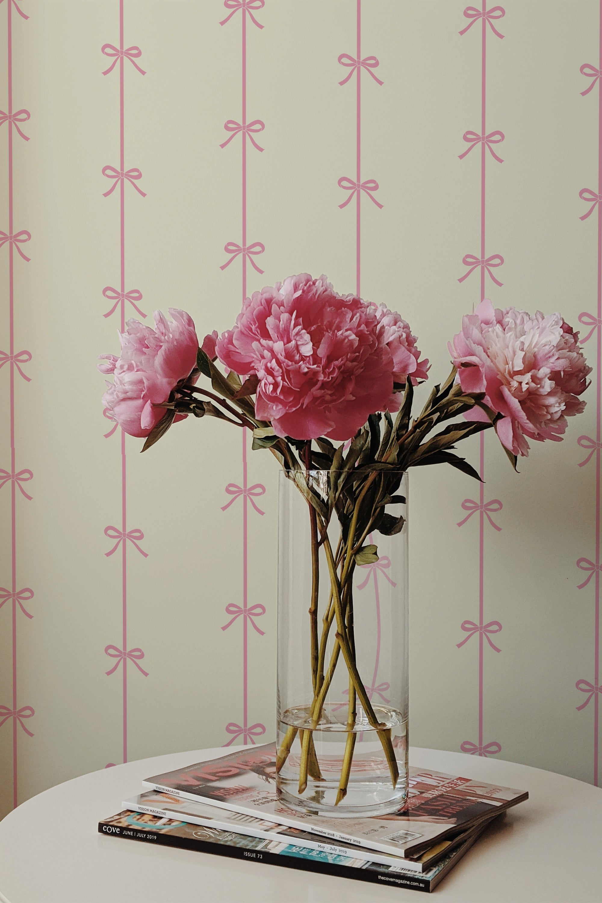 Self-adhesive wallpaper with a vintage bow lines pattern, alternating pink bows and vertical stripes on a creamy background.