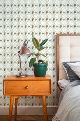 Self-adhesive Vintage Lobster wallpaper with repeated crustacean motif against a patterned background, accenting a cozy bedroom corner with a bedside table and lamp.
