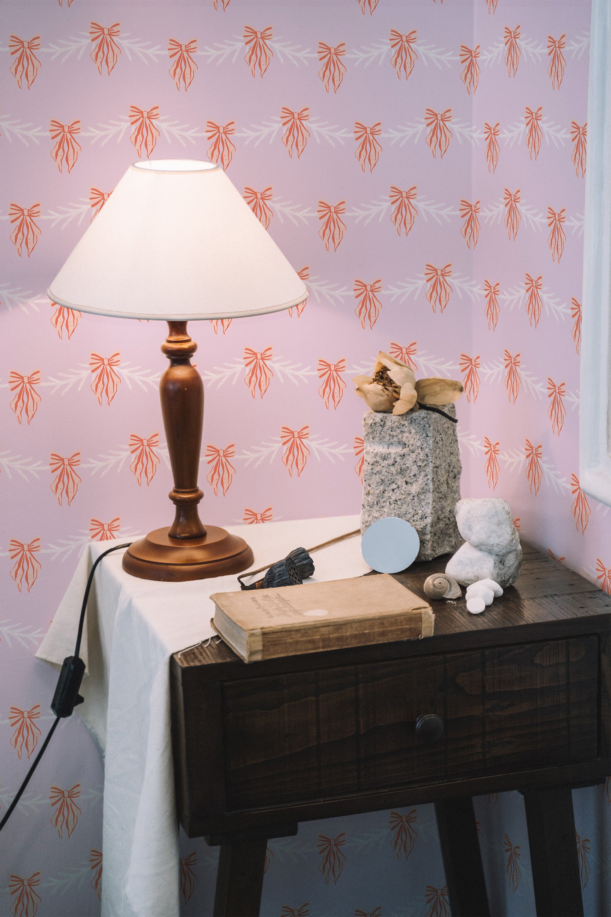 peel and stick wallpaper pink christmas bow pattern accent wall bedroom nightstand interior