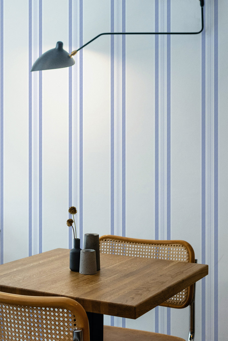 wooden dining table rattan chairs classic blue french stripes peel and stick wallpaper