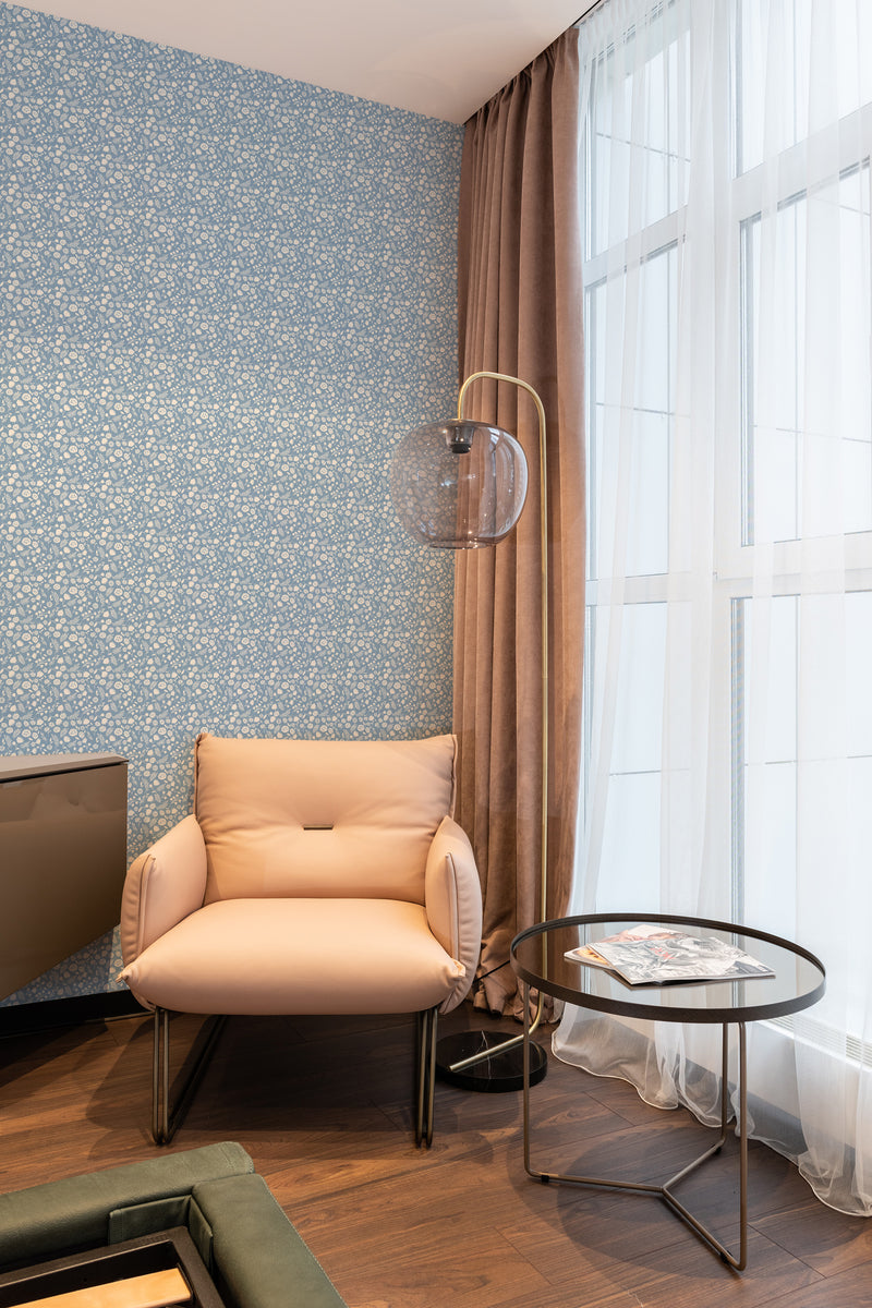 wallpaper stick and peel blue and white florals pattern modern armchair lamp table reading area