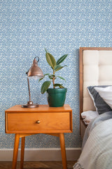 stylish bedroom interior nightstand plant lamp blue and white florals accent wall