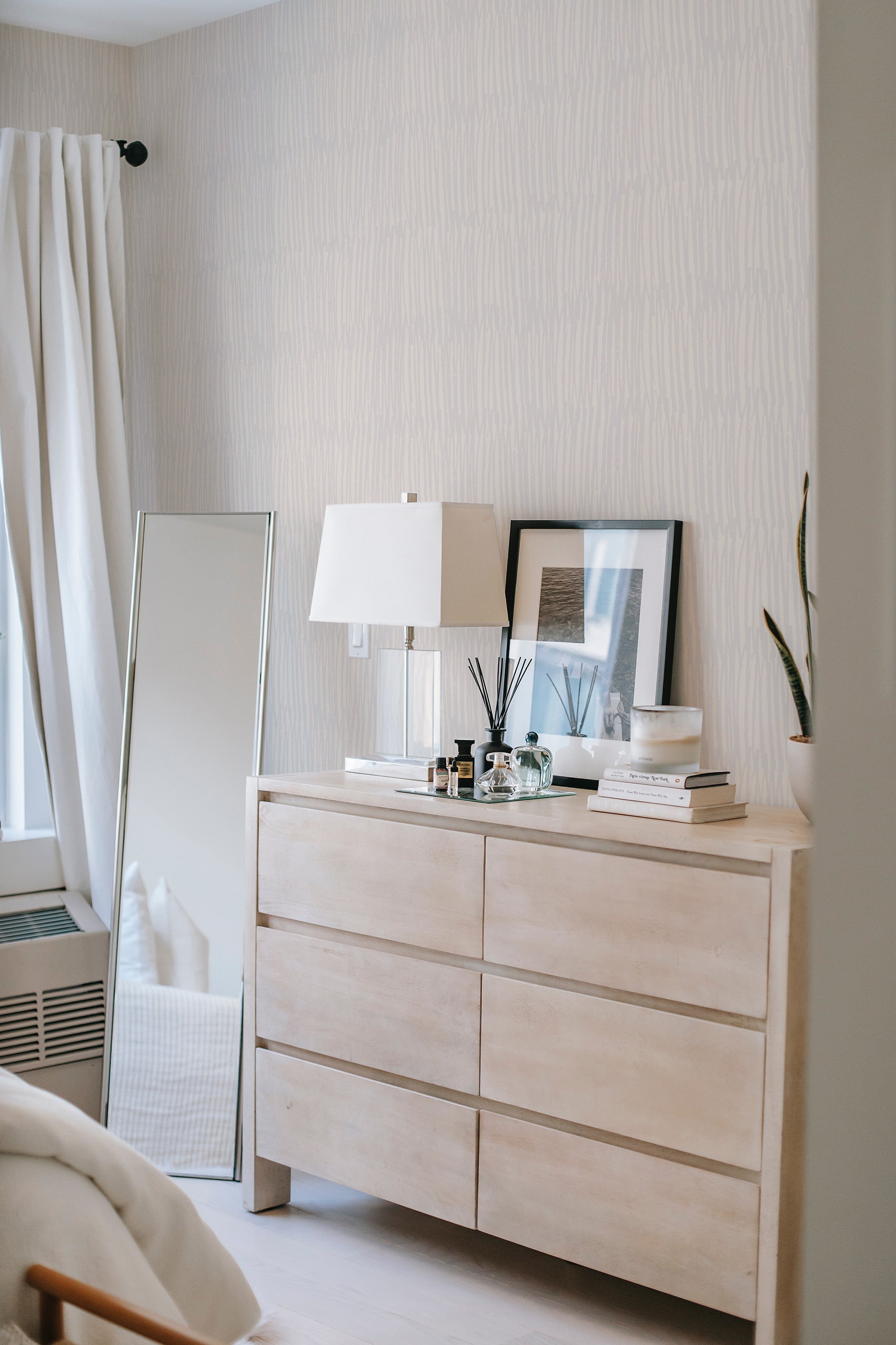         
peel and stick wallpaper calming brush strokes accent wall bedroom dresser mirror minimalist interior