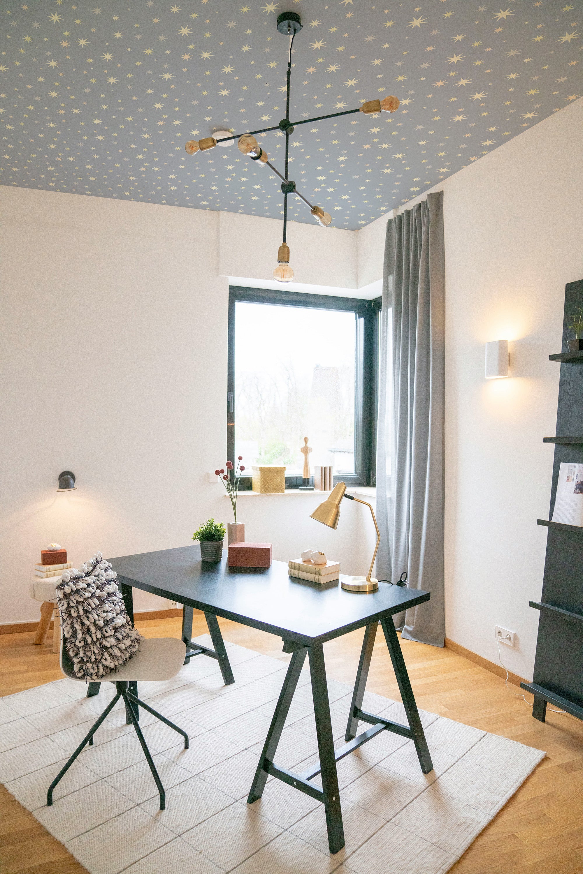Modern home office with a desk, chairs, and decorative elements.