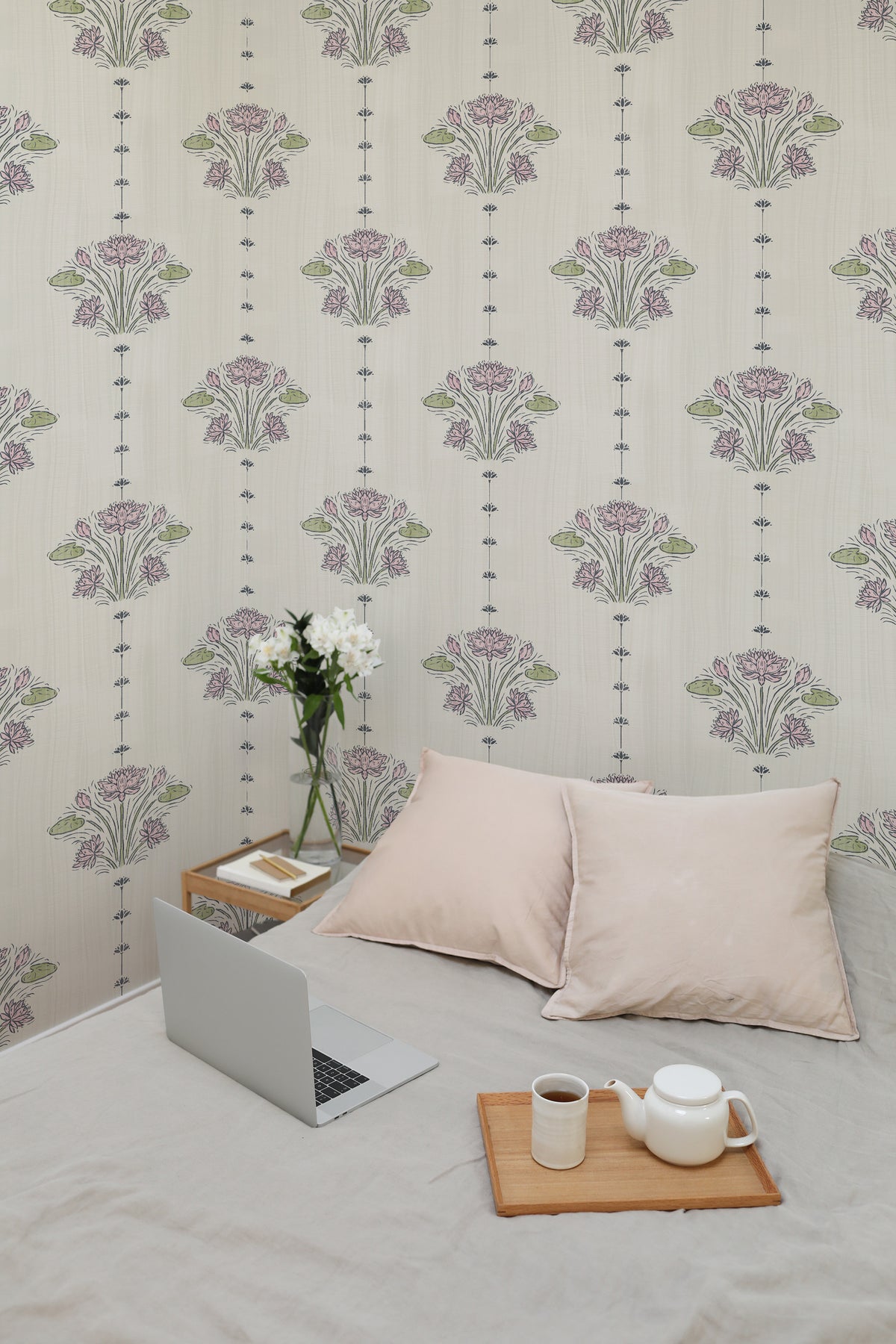 Delicate Lotus Sprigs peel and stick wallpaper on a bedroom wall, spaced pink lotus bouquets with vertical dotted stripes.