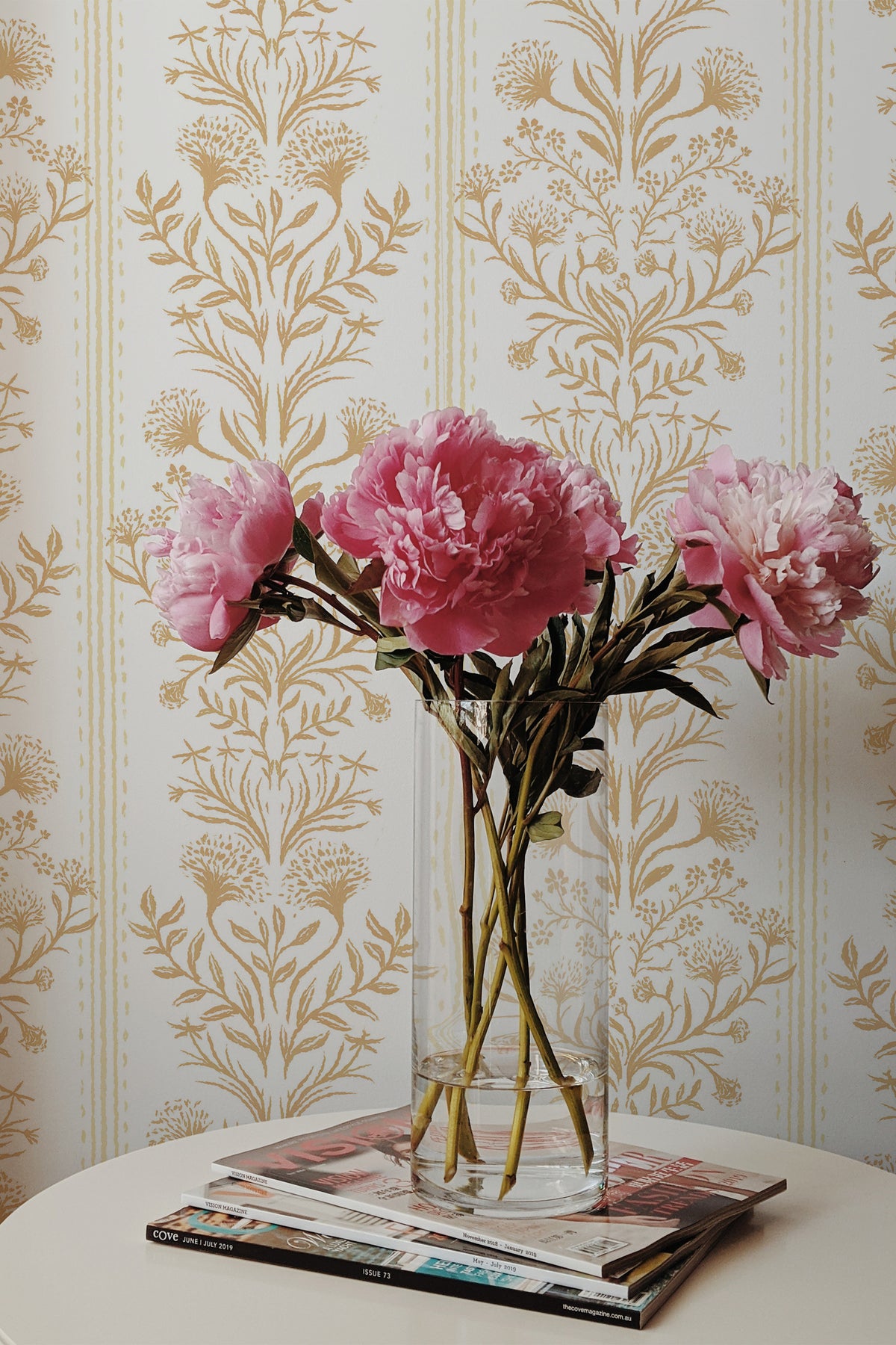 Ornate Damask peel and stick wallpaper on an interior wall with tan damask motifs and narrow stripes on off-white.