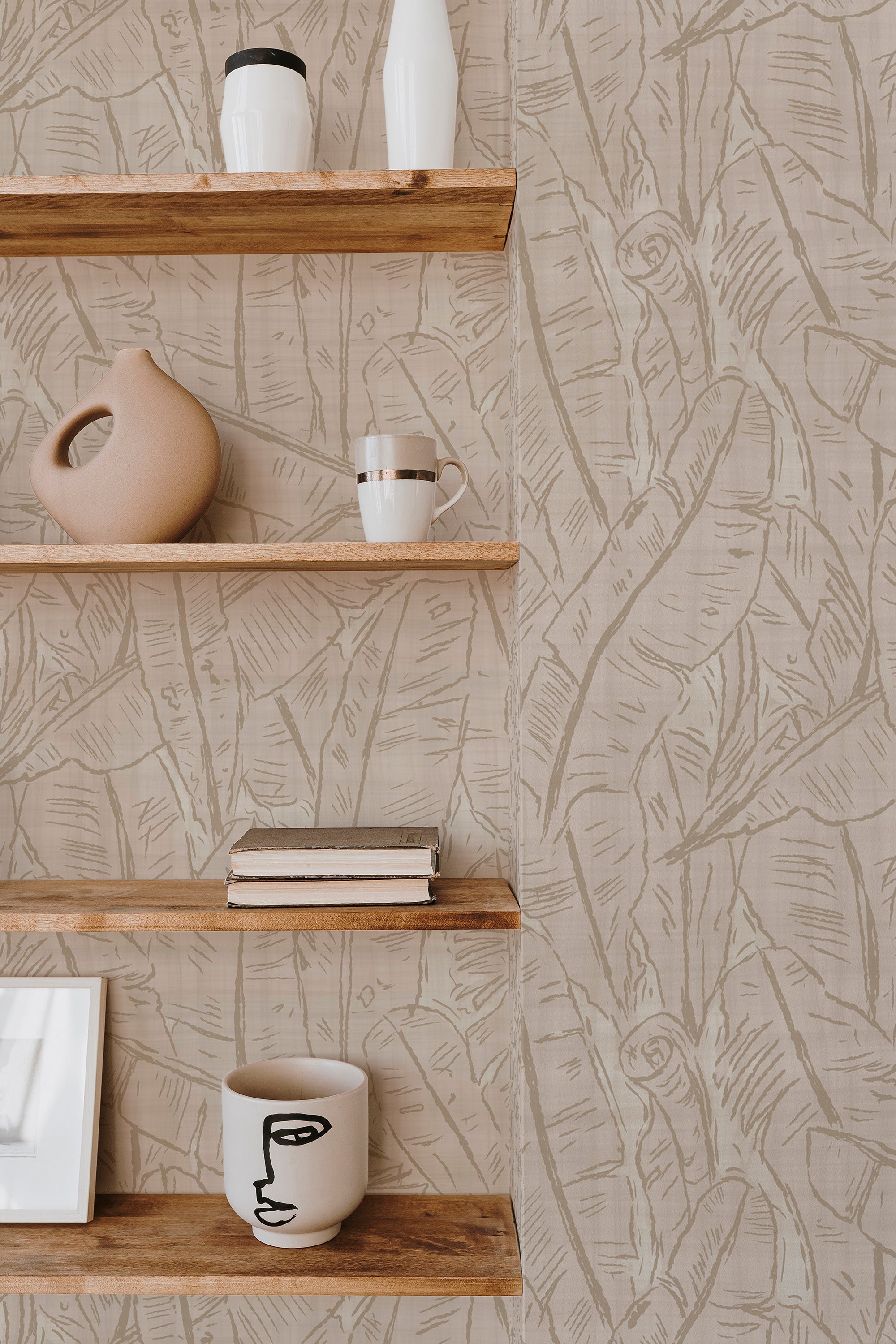 Tropical Sketch non-pasted wallpaper on a full interior wall, showing tan line-drawn tropical leaves on a light beige ground.
