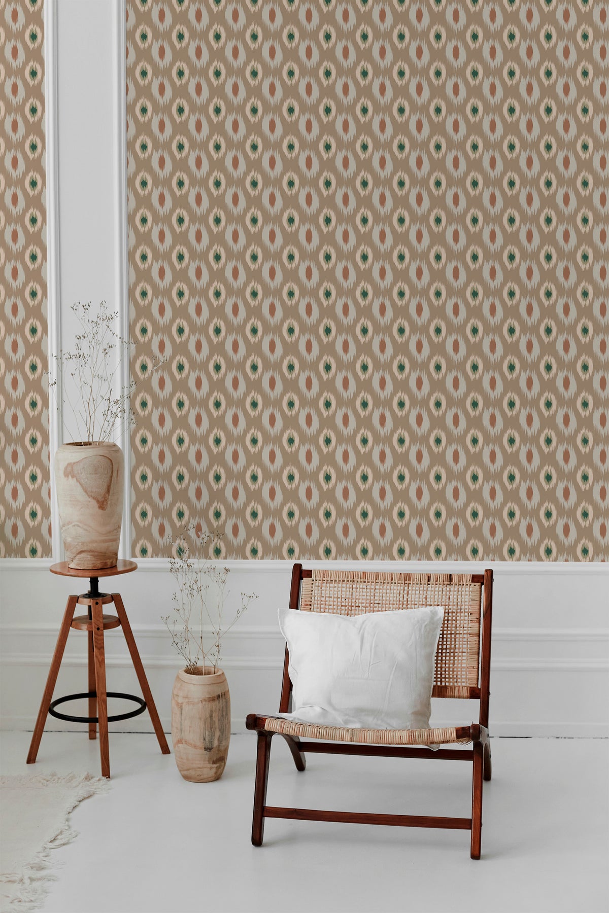 Jagged Ikat Ovals peel-and-stick wallpaper on an interior wall, tan ovals with green centers in a repeat.