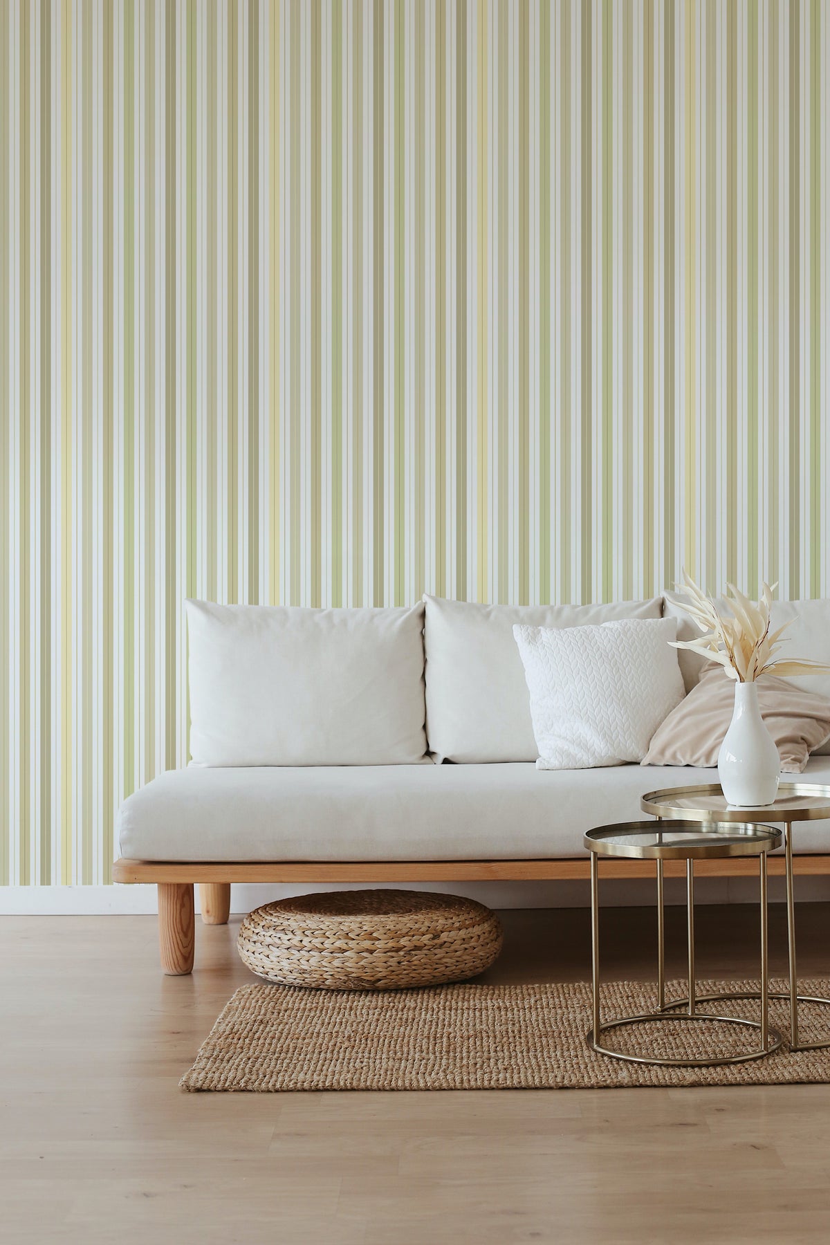 Soft Vertical Stripes peel and stick wallpaper on a living room accent wall with pale green and cream stripes.