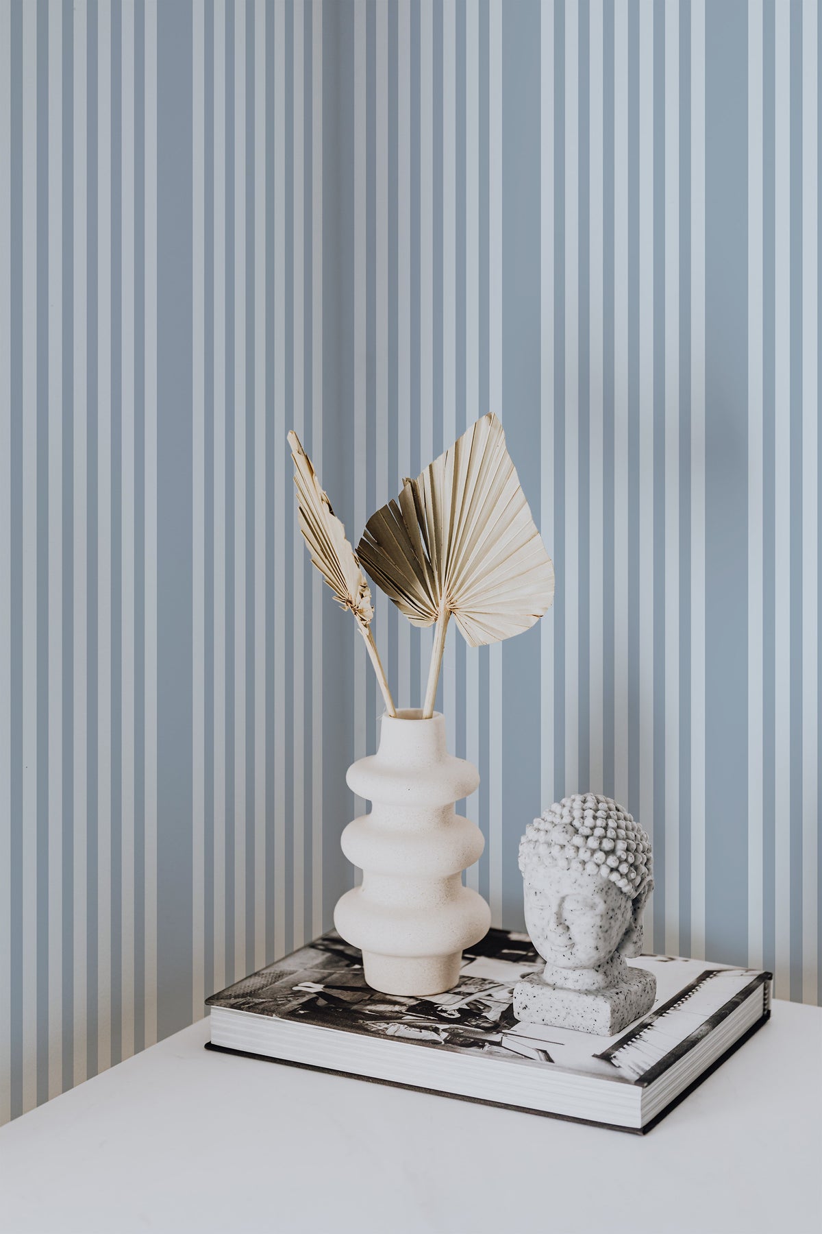 Classic Vertical Stripe self-adhesive wallpaper on an interior wall, featuring thin and wide blue vertical stripes.
