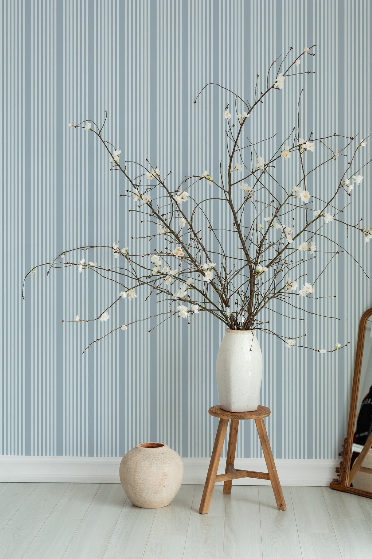 Classic Vertical Stripes pre-pasted wallpaper on an interior wall, showing narrow blue stripes at full-wall scale.