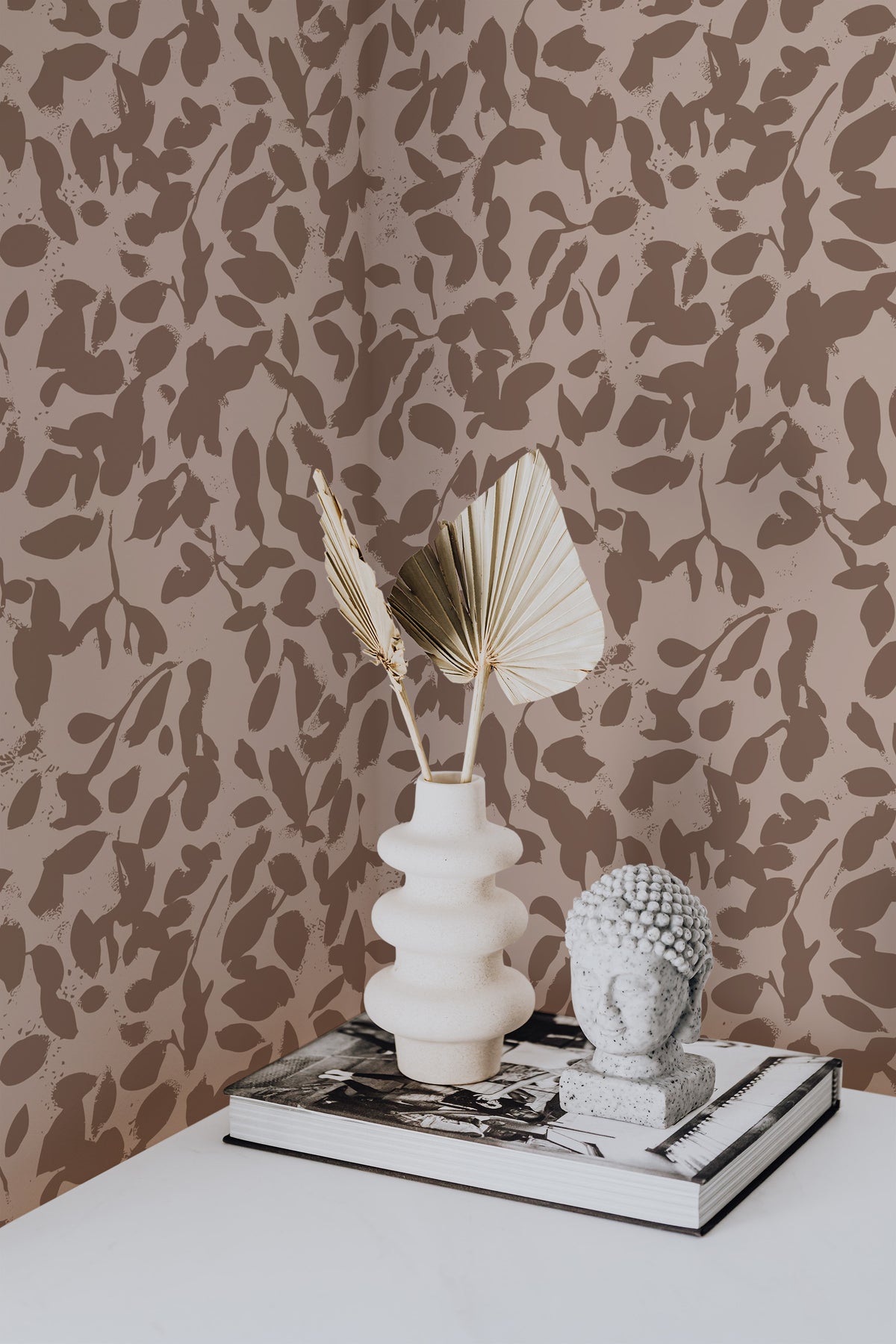 Rustic Leaf Silhouettes grasscloth wallpaper on an interior wall with brown leaf shapes on taupe.